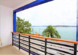 a balcony with a view of the water at JAZEERA RESORT in Port Blair