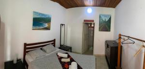 a bedroom with a bed in a room with at Vila Marilyn in São Tomé