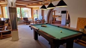 a living room with a pool table in it at Chesa Bellaval, Haus Rizza 2 1 2-Zimmerwohnung in Silvaplana