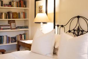 1 dormitorio con 1 cama con almohadas blancas y lámpara en Prince Albert Country Stay, en Prince Albert
