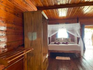 a bedroom with a bed in a wooden cabin at Kohjum Relax Beach in Ko Jum