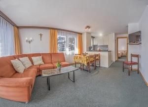 a living room with a couch and a table at Apartments Bergrose in Saas-Fee