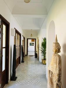 a hallway with a statue in the middle of a room at Casa Azul- Luxury 4bhk Assagao with private pool in Vagator