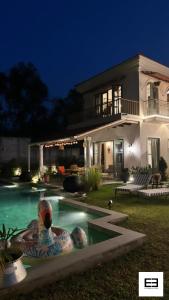 a house with a swimming pool in front of it at Casa Azul- Luxury 4bhk Assagao with private pool in Vagator