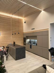 a kitchen with a island in the middle of a room at Lakeside Lodge Norvis in Rovaniemi