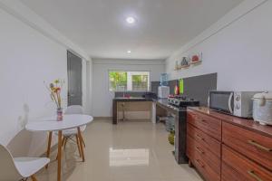 a kitchen with a table and a counter top at Sunrise Villa Sanur in Sanur