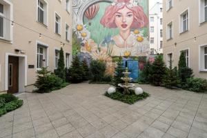 a mural on the side of a building with christmas trees at Cozy & Elegant Studio with Netflix Poznan Old Town by Renters in Poznań