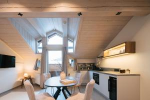 a kitchen and dining room with a table and a window at Boutique Apart Serfaus in Serfaus