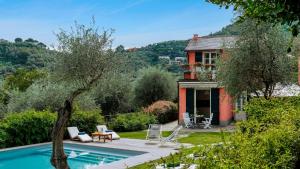 a house with a swimming pool in the yard at VILLA BELLAVISTA 8&1, Emma Villas in Santa Margherita Ligure