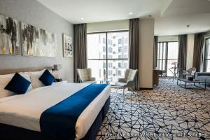 a hotel room with a bed and a large window at Grand Kingsgate Jaddaf Waterfront Hotel by Millennium in Dubai