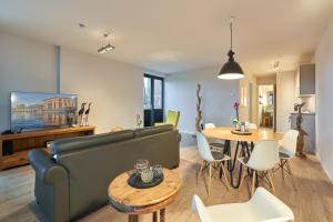 a living room with a couch and a table at havelblau Ferienlofts in Brandenburg an der Havel