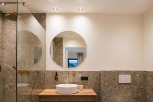 a bathroom with a sink and a mirror at Boutique Apart Serfaus in Serfaus