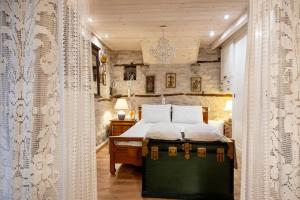 a bedroom with a bed in a room with curtains at Studio Penelope in Kerasochórion