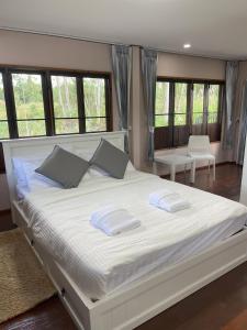 - une chambre avec un grand lit blanc et 2 oreillers dans l'établissement Paradise Pool Villa at My Second home, à Ban Chang