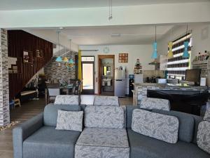 a living room with a couch and a kitchen at Villa Aahana - Flic en Flac in Flic-en-Flac