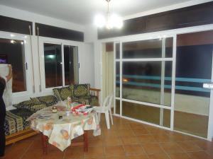 un soggiorno con un tavolo e un divano di Appartement CORNICHE vue sur MER a Martil
