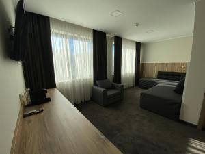 a living room with a couch and a chair at Комплекс Дунав in Ruse