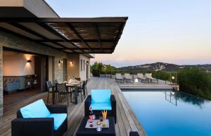 a patio with a pool and a table and chairs at Villa Nepita in Lecci