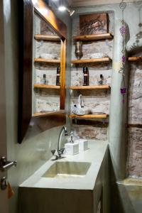 a bathroom with a sink and a mirror at Studio Penelope 