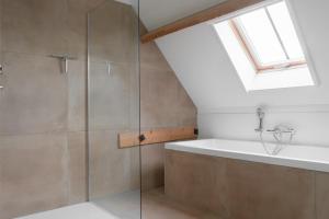 a bathroom with a shower and a bath tub at Vakantiehuis Nijmegen in Erlekom +115 photos