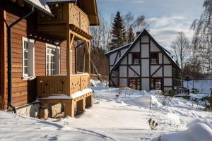 a house with a porch in the snow at Milkowa Dolina in Szklarska Poręba