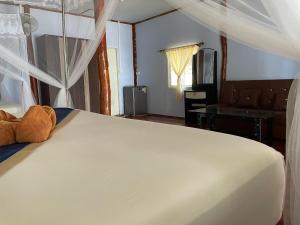 a bedroom with a bed with a teddy bear on it at Kohjum Relax Beach in Ko Jum