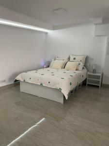 a white bedroom with a bed in a room at Studio1 in Suceava