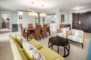 a living room with a couch and a dining room at OUTRIGGER Kaua'i Beach Resort & Spa in Lihue