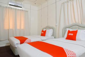Postel nebo postele na pokoji v ubytování OYO 90037 The 7 Lodge Tambunan