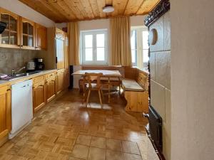 a kitchen with a table and a dining room at Pension Sedlak in Millstatt