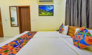 a bedroom with two beds in a room at FabExpress Purple Suites Inn in Bangalore