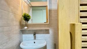 a bathroom with a sink and a mirror at Muji Hotel KrabI in Krabi