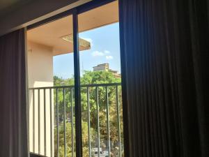 a window in a room with a view of a balcony at Balaji Inn Guest House, Panjim in Panaji