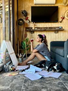 a woman sitting on a couch with a dog eating at Residencia Artistica CasaVino in Casablanca +20 photos