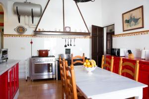 a kitchen with a table with a bowl of fruit on it at CORTIJO RURAL LA MARISCALA in Jerez de la Frontera