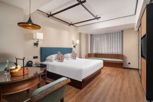 a hotel room with a bed and a dining room at SSAW Boutique Hotel Shanghai Bund in Shanghai