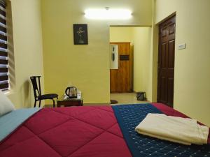 Katil atau katil-katil dalam bilik di Mystique Inn Wayanad