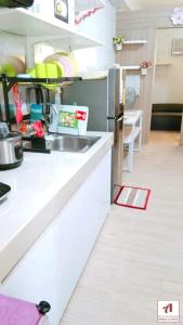 a kitchen with a sink and a counter top at Amaze365 Holiday Homes Condotel at Trees Residence Fairview in Manila