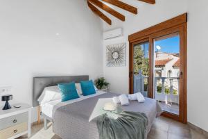 a bedroom with a bed with blue pillows and a window at Villa K9 Ortenbach in Ifach +36 photos