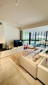 un soggiorno con divano e TV di Deluxe Garden Apartment at Marea Resort a Golem