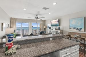 a kitchen and living room with a view of the ocean at Windancer 211 in Destin