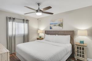 a bedroom with a bed and a ceiling fan at Windancer 211 in Destin