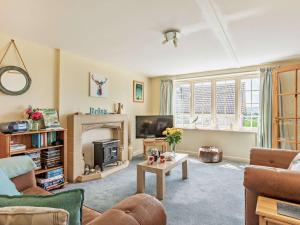 a living room with a fireplace and a tv at 1 Bed in Lyme Regis WHOUS in Axminster