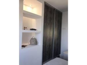 a bathroom with a wooden cabinet in a room at Villa Avra in Ierápetra