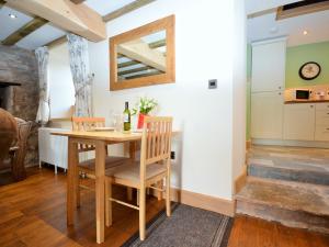 a kitchen and dining room with a table and chairs at 1 Bed in Coleford 37217 in Bream