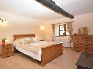 a bedroom with a bed and a dresser and a window at 1 Bed in Coleford 37217 in Bream