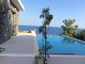 a swimming pool with a view of the ocean at Villa Avra in Ierapetra