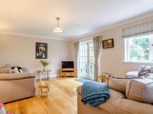 a living room with two couches and a tv at 5 Bed in Dereham 89542 in Swanton Morley