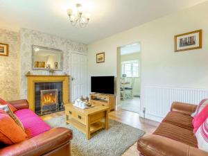 a living room with a couch and a fireplace at 2 Bed in Kielder 89299 in Falstone