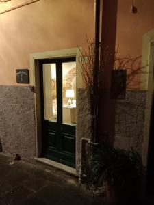 a door to a building with a window and a lamp at DEMIVIE GUESTHOUSE in Lerici